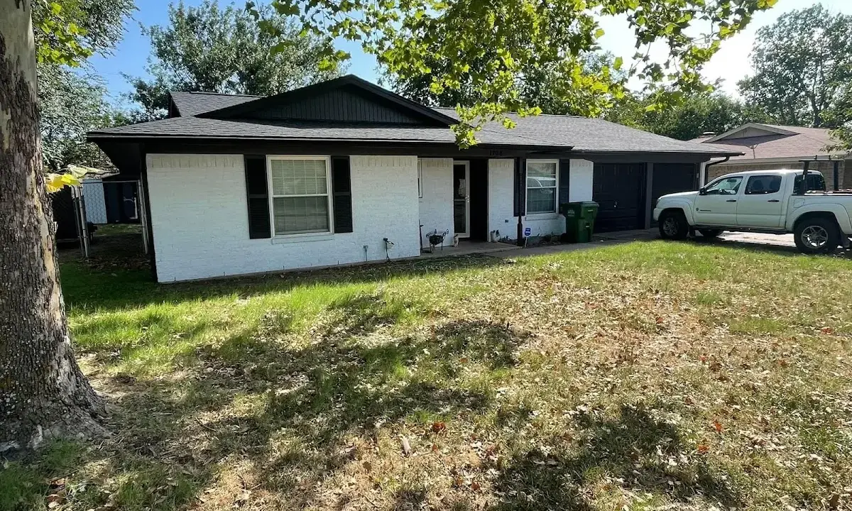 Professional roofing crew working on a residential roof in Grinnell